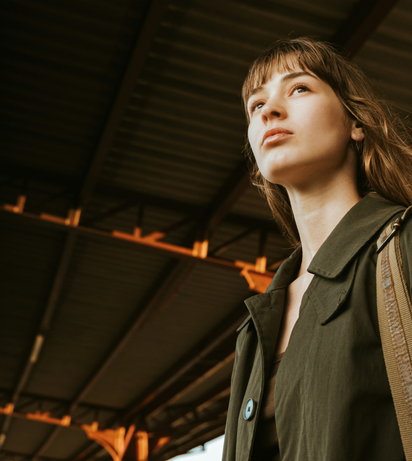 Woman standing under a roof and waiting